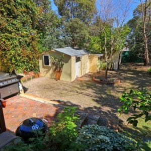 rear garden area with sheds and rear access.