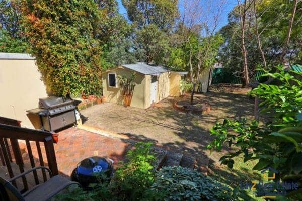 rear garden area with sheds and rear access.