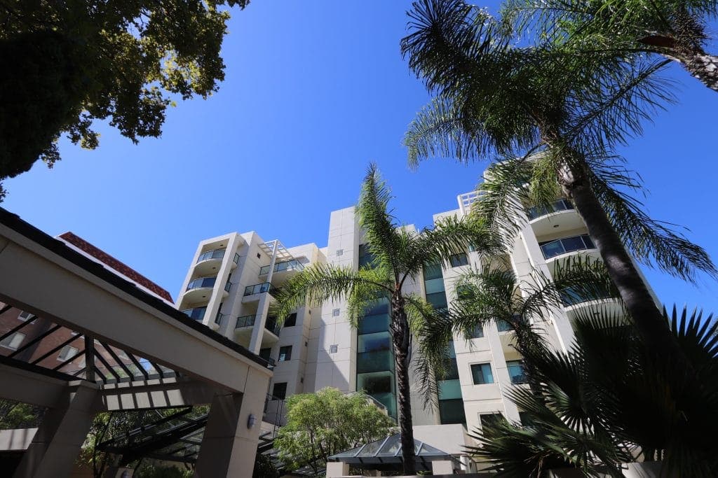 picture of apartments and blue sky in the background.