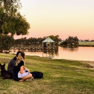 A couple and their dog enjoy a sunset picnic in Bayswater