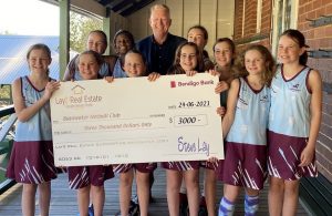 Bayswater Primary School Netball Sponsorship photo June 2021 - Steve Lay of Lay2 Real Estate and some of the team members image with sponsor cheque.